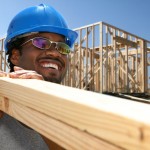 Construction worker carrying lumber