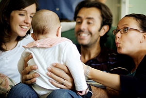 Family smiling at baby