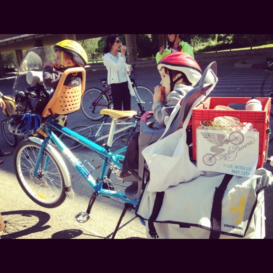 Bike rigged up to carry two small kids.