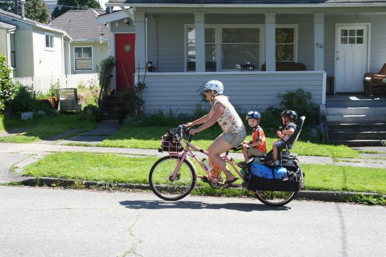 Mom and two kids in tow on a bike