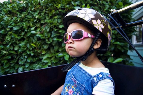 Anastasia with bike helment and cool sunglasses. Courtesy: Patrick Barber, blog.mcguirebarber.com.