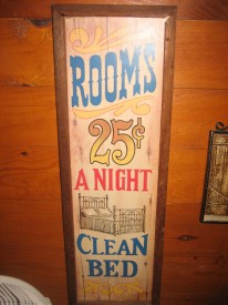 Sign reading "Rooms, 25 cents a night, clean bed."