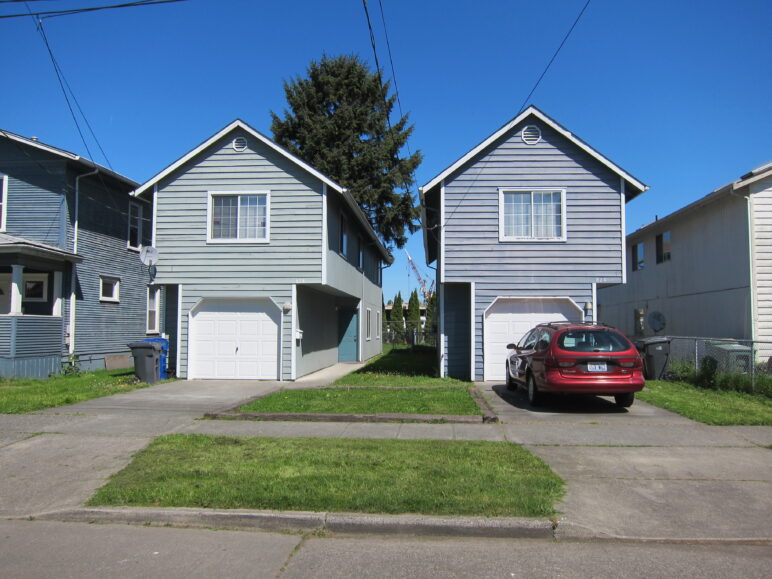 These houses in South Seattle have a covered garage instead of a carport, but the dingbat form is much the same. Photo by Alyse Nelson.
