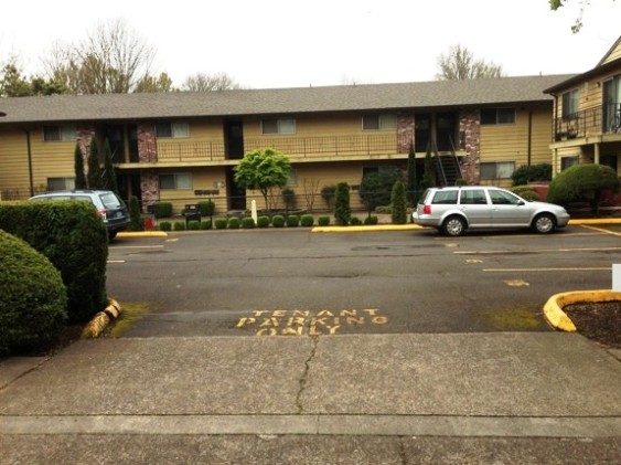 A parking court in a 2-level apartment buliding.