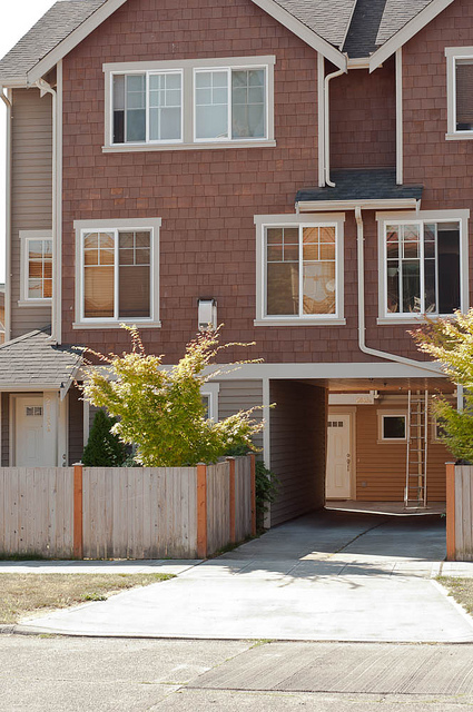 Townhouses with privacy fencing on street.