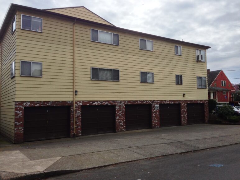 Ground level garages dominate the appearance of this apartment building.