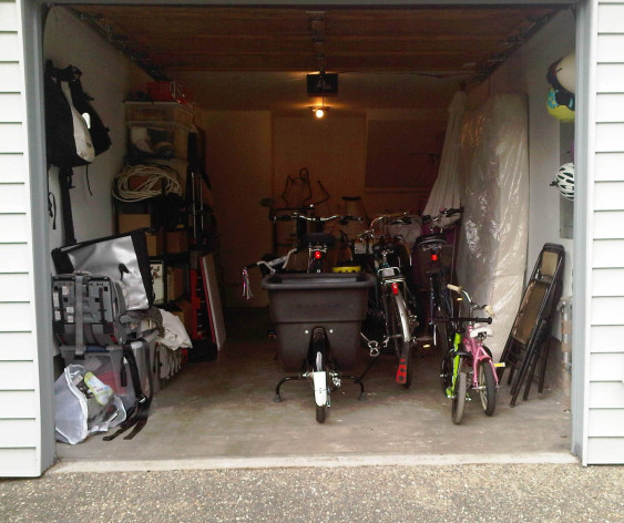 Bikes and a matress in a garage.