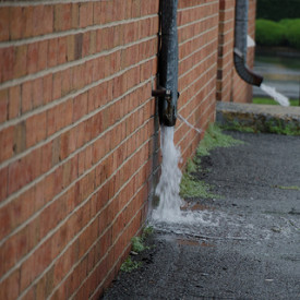 Rain water gushes from downspouts, photo from Flickr's geronimo819, Creative Commons. 