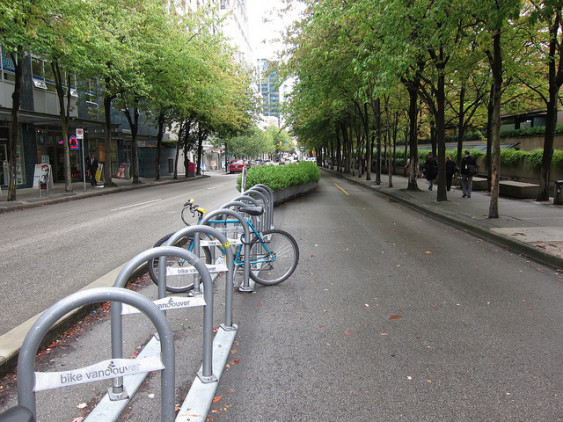 Bike racks and planters buffer people biking from cars along Vancouver’s downtown separated cycle lanes. Photo by Alyse Nelson, used with permission.