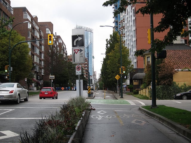 Other intersections have separated right turn lanes and use signage to remind people driving to yield. Photo by Alyse Nelson, used with permission.