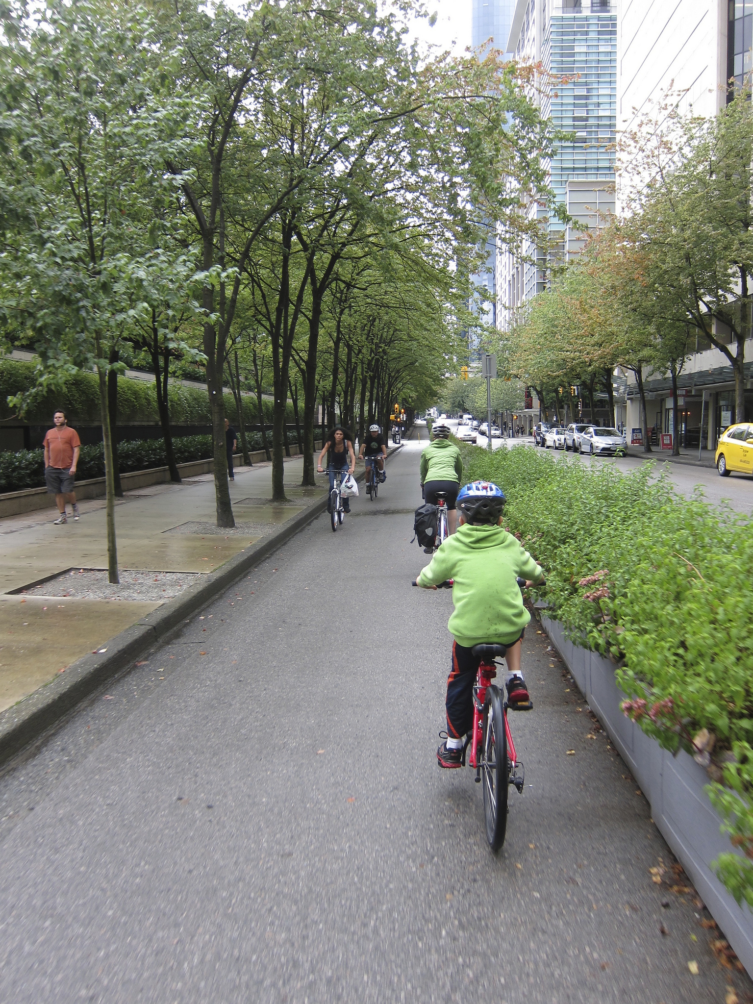 The author and her son pedal through downtown Vancouver, BC, on a separated cycle lane. Photo by Alyse Nelson, used with permission.