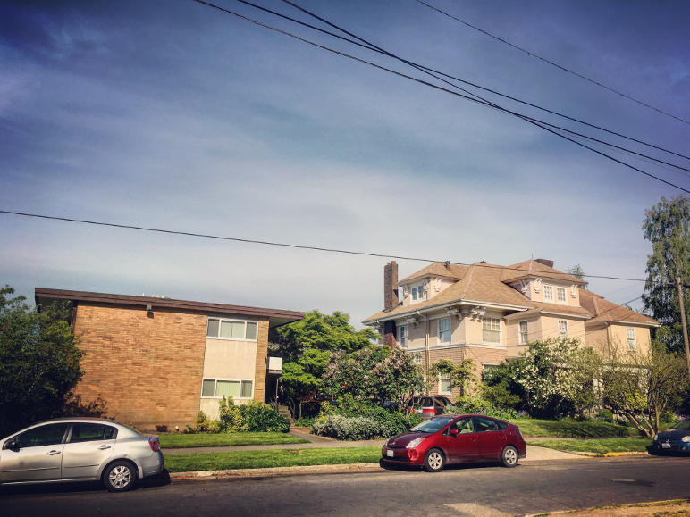 Small apartment building next to large house in Seattle. Photo by Dan Bertolet.