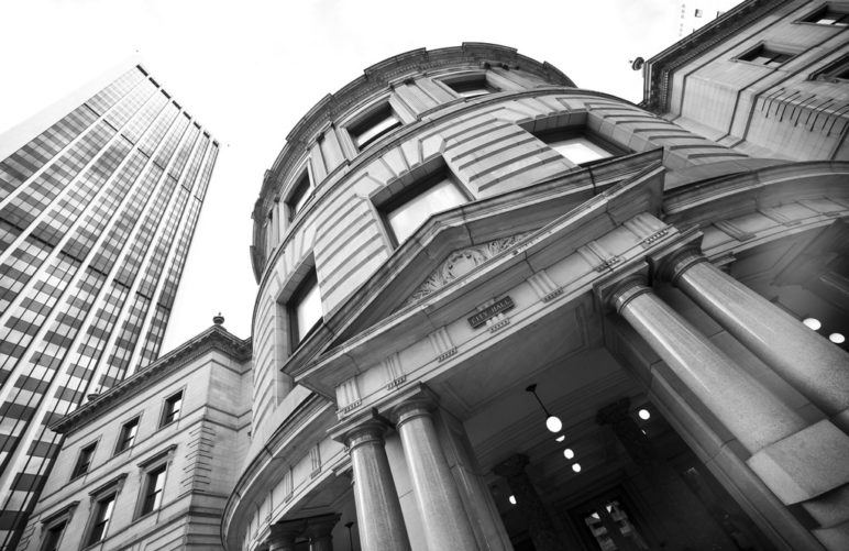 A black and white image of the entrance to Portland's city hall.
