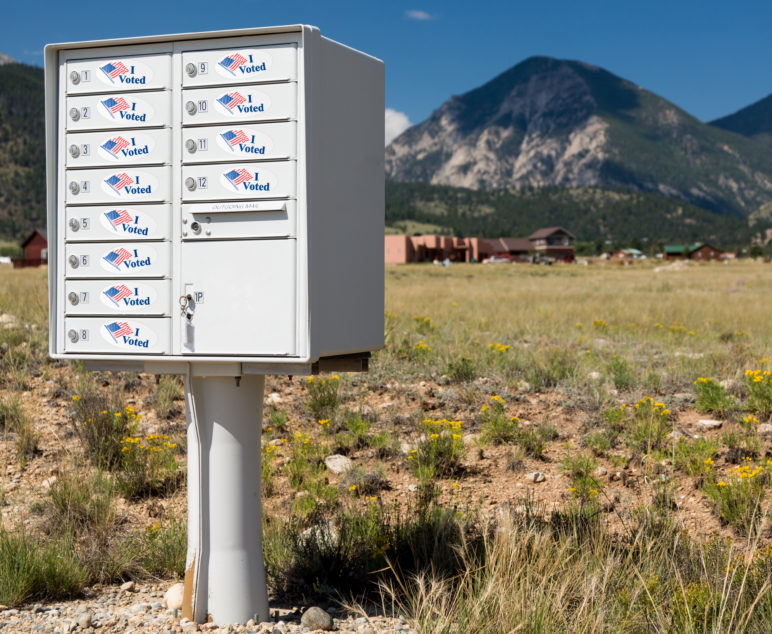 Rural mailboxes with "I voted" stickers on them.