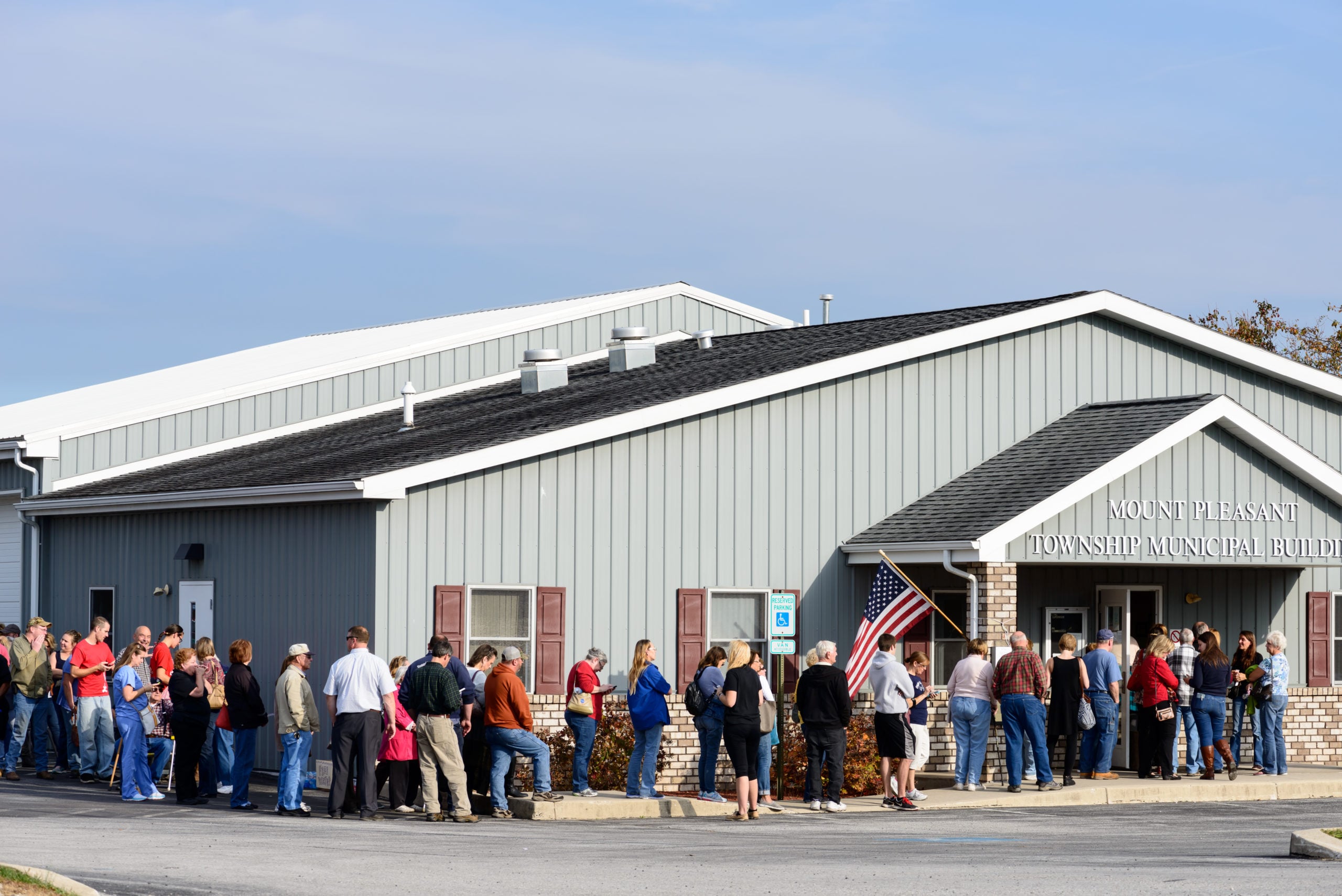 Voters lining up around the block outside a polling place. Election Day.