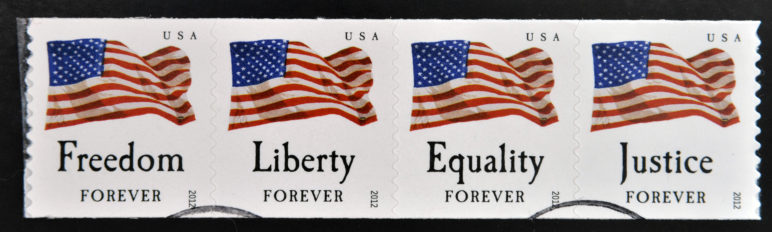 US Postal Service American Flag stamps with the words freedom, liberty, equality, and justice.
