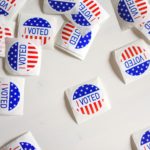Scattered "I voted" stickers on a white background
