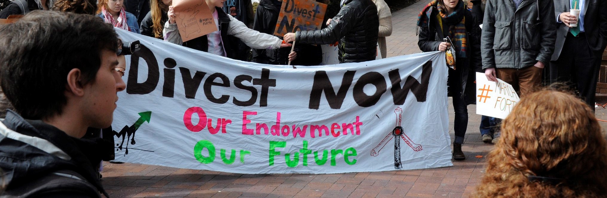 Banner at a rally: "Dives. Our endowment, our future."t now
