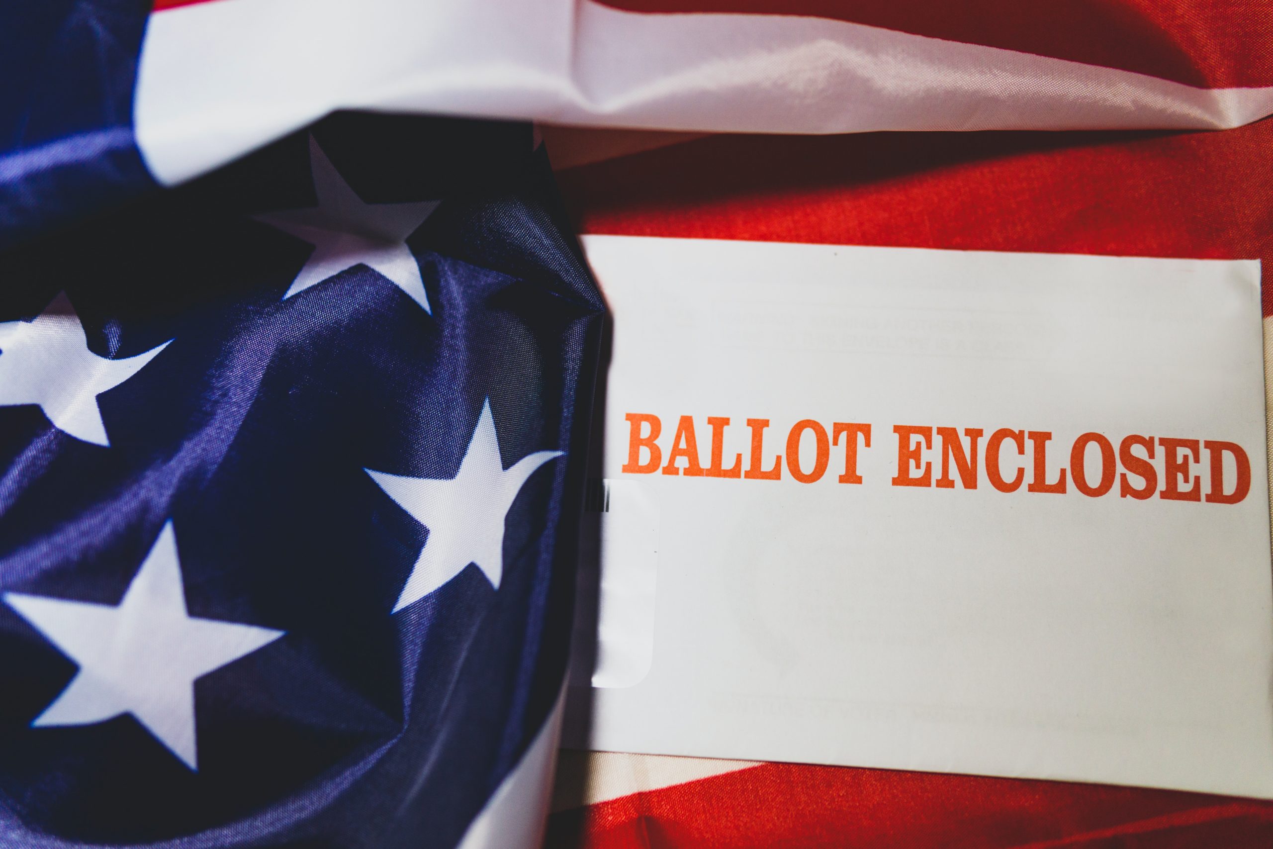 American flag with a "ballot enclosed" card in front