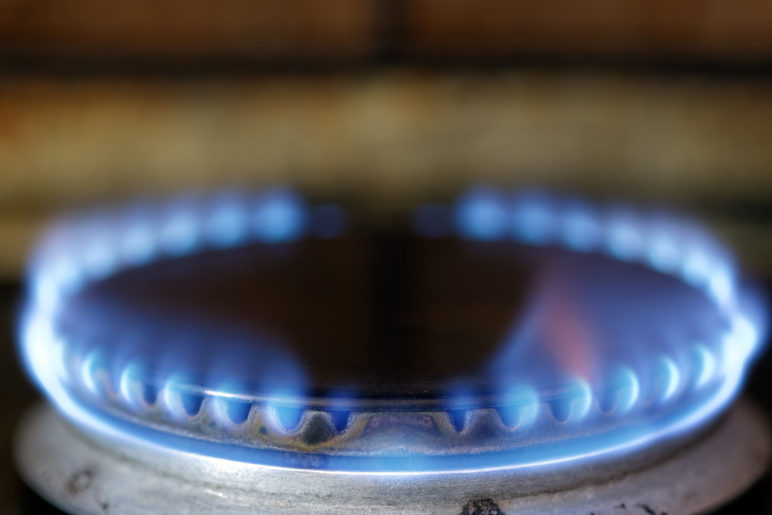A close-up view of the blue flame from a gas stove burner.
