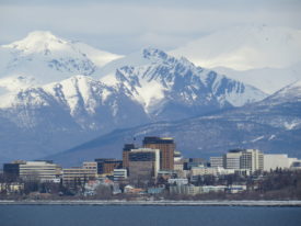 Photo of downtown Anchorage, with the Chugach Mountains in the background.