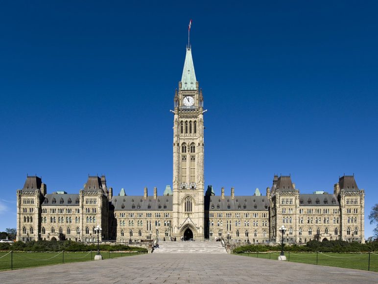 Centre Block, Canadian Parliament building, looking head on during the daytime.