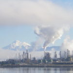 Tesoro and Shell Puget Sound oil refineries at Anacortes WA. Mount Baker is seen amidst the steam and smoke.