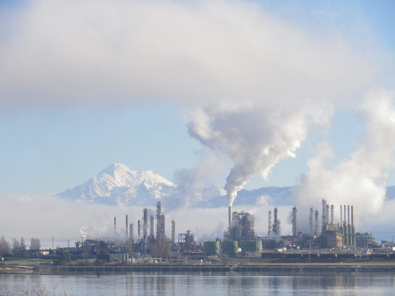 Tesoro and Shell Puget Sound oil refineries at Anacortes WA. Mount Baker is seen amidst the steam and smoke.