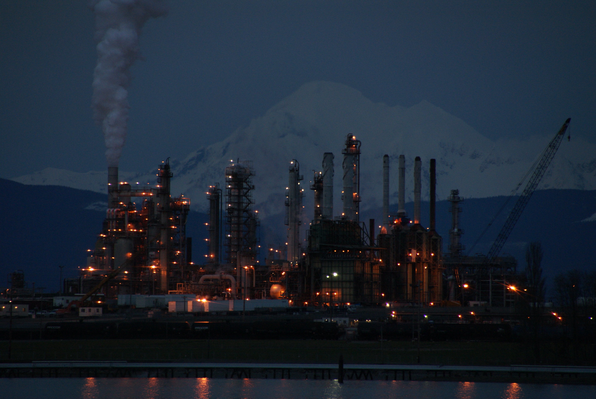Photo of oil refinery in Anacortes at night, with a plume of smoke emanating from one of the stacks