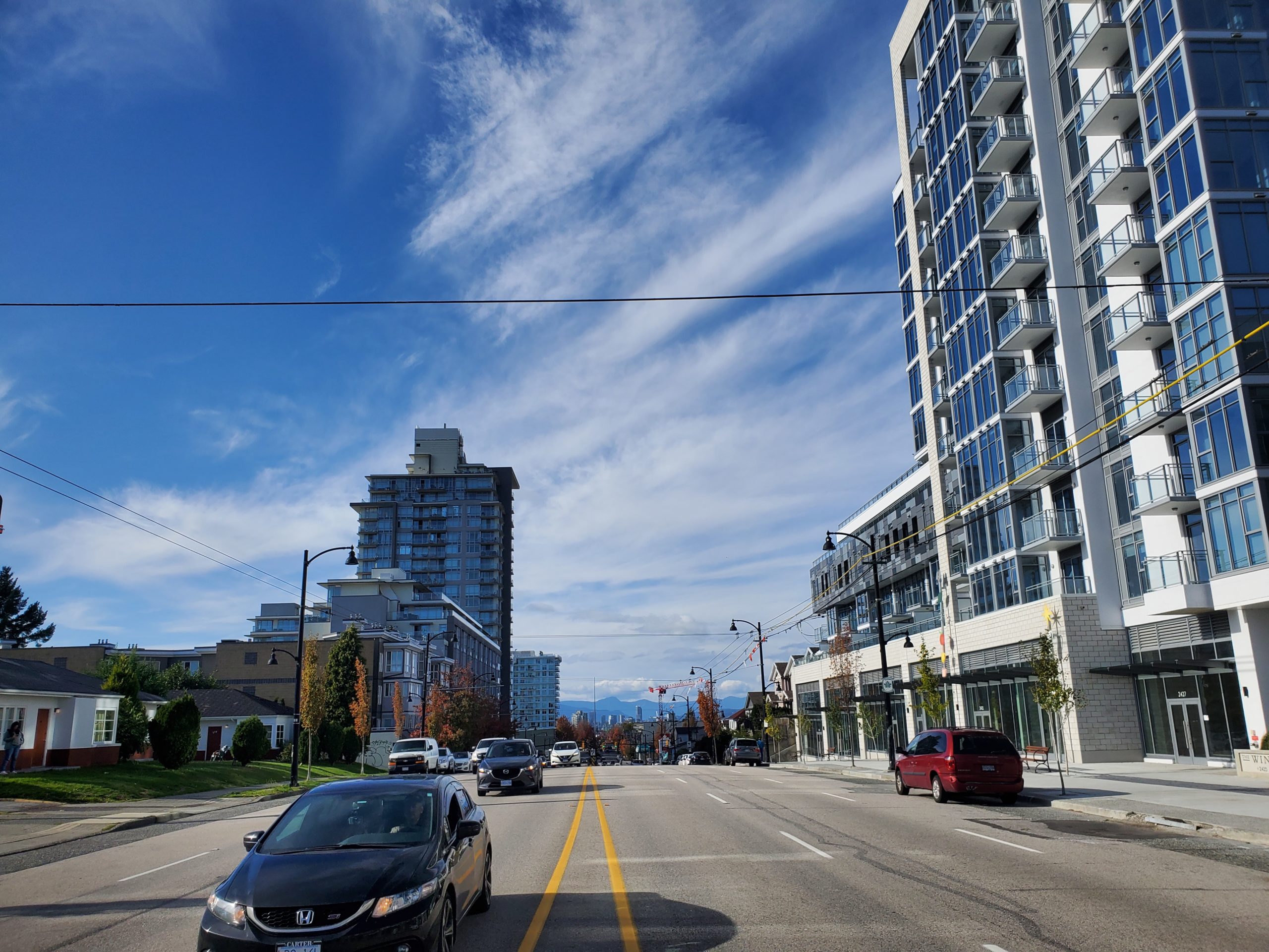 Photo of arterial road lined with buildings of varying heights.