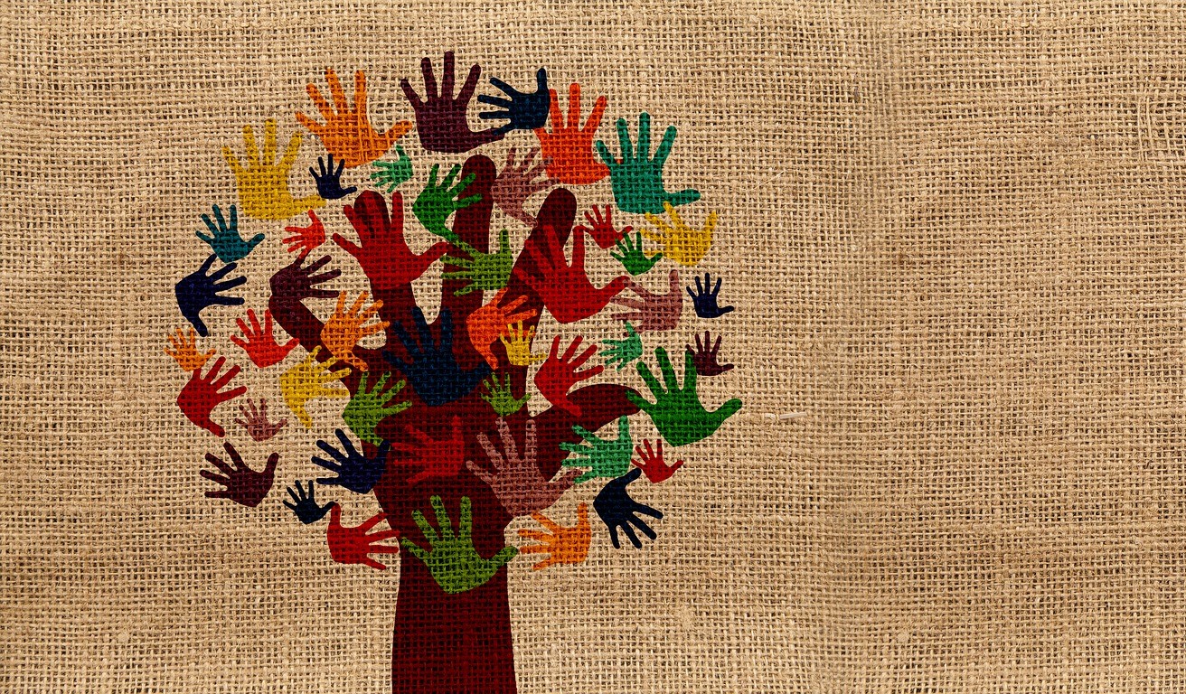 Illustration of a tree made out of colorful handprints