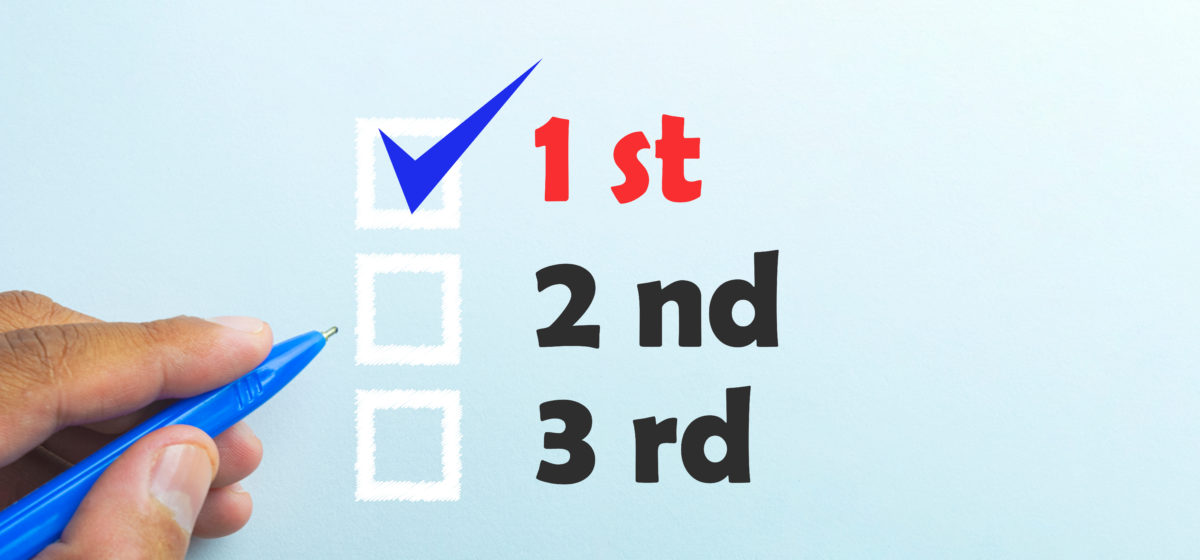 Checklist itemizing "1st, 2nd, 3rd" options and a person poised with a pen.