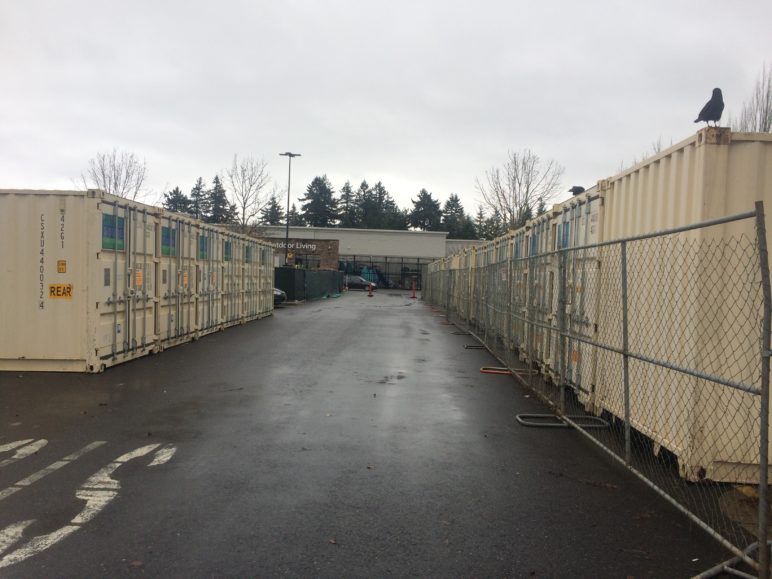 Photo of a Walmart parking lot, with shipping containers taking up spots instead of cars