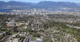 Photo of the Cambie Corridor facing Downtown Vancouver with single family houses in front.