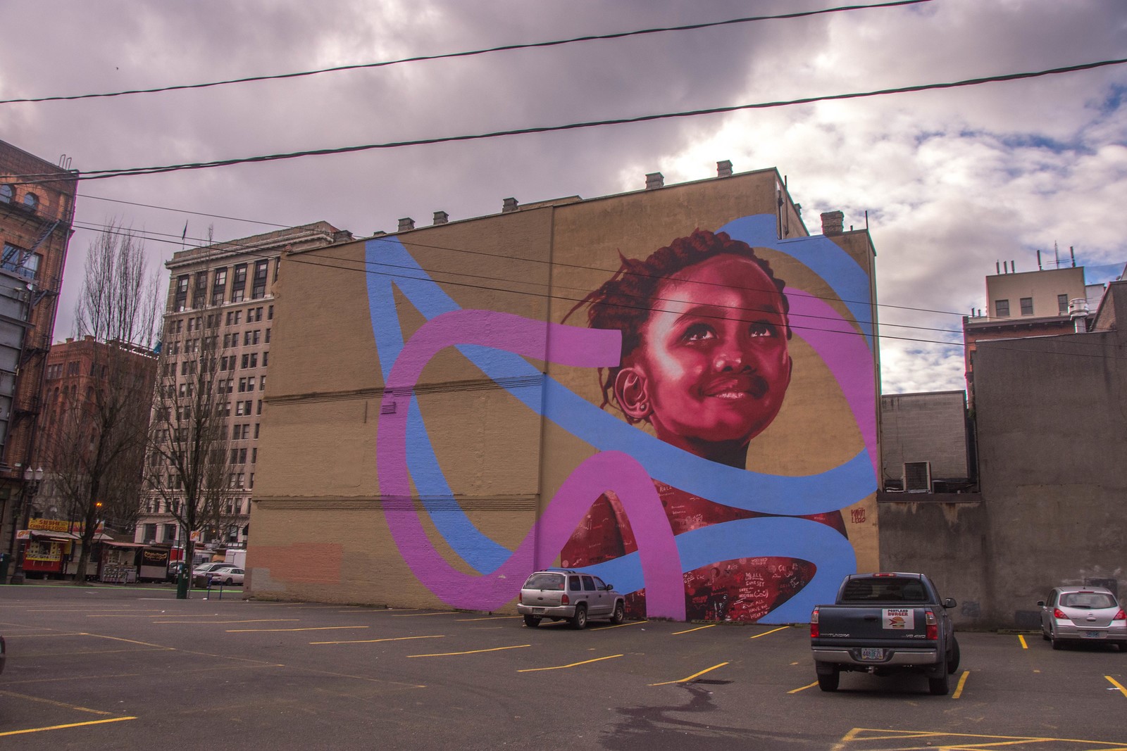 A parking lot in downtown Portland, Oregon with a very cool graffiti art prominent