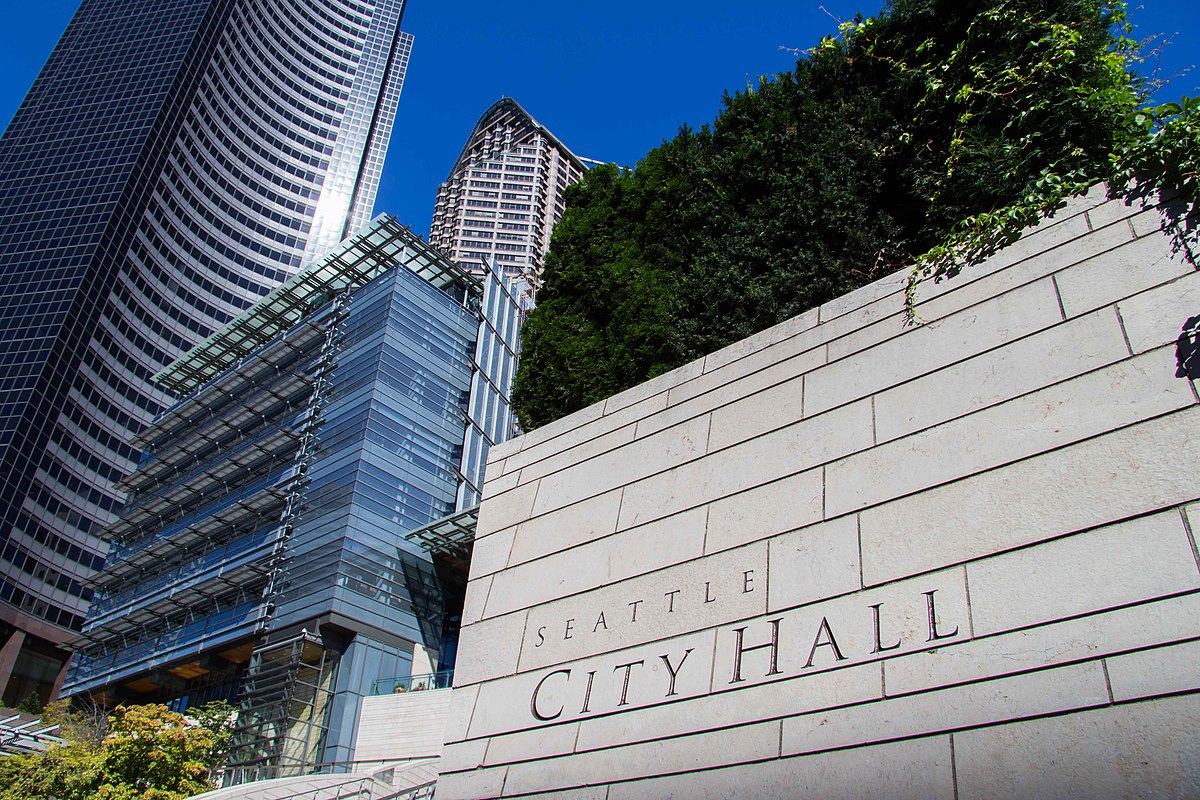 Photo with the words "Seattle City Hall" prominently displayed on the side of the wall