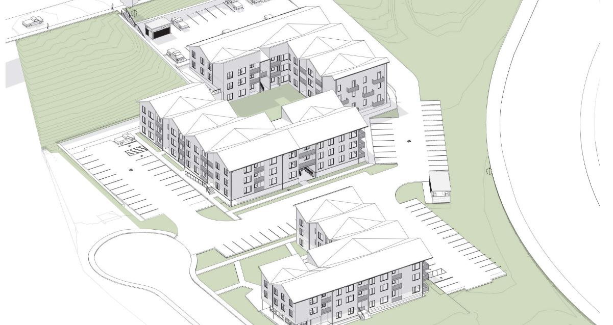 rendering of an apartment complex as seen from above. Three buildings are surrounded by parking spaces, which are surrounded by green space.