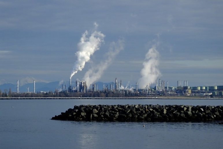 A sprawling refinery billowing smoke over the blue of Anacortes' waters.