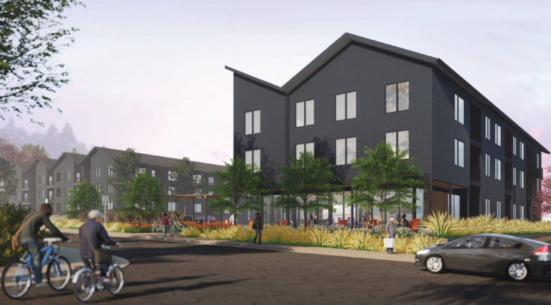 This affordable housing development in Troutdale has re-filed for permits after being blocked for months. Dark grey apartment building with simple garden and greenery along the sidewalk. Image by Home Forward. 