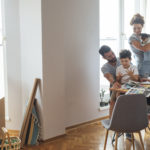 Family moving into a new home with bright white lighting. Zoning reform could make more kinds of homes affordable in Washington job centers, for households of a range of incomes.