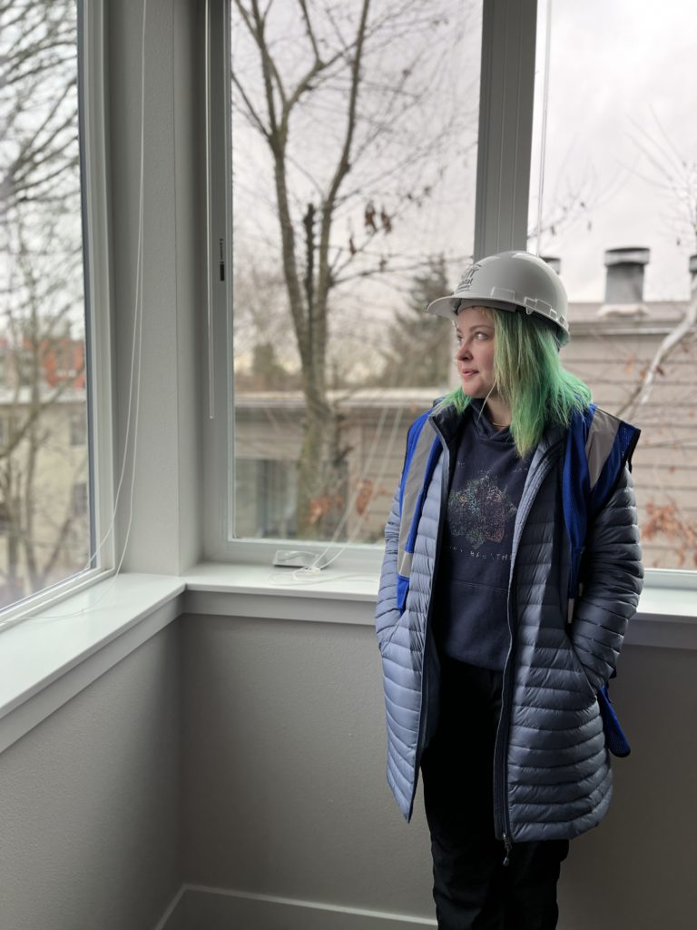 Veronica Fleming looks out the window of her new home, currently in the last stage of construction. Photo by Catie Gould. 