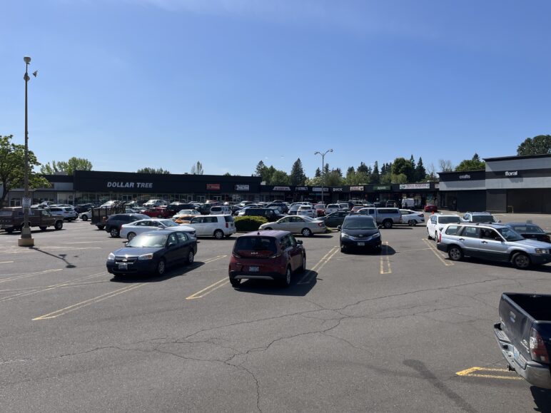 Photo of a parking lot in a strip mall on a sunny day