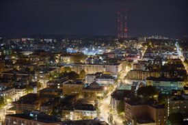 Night time photo of Seattle, WA with the lights glowing to form a "vein" of the city