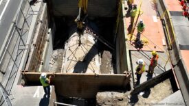 Workers connect a sewer line to the South Lake Union Energy District in 2023 in one of the United States’ first large commercial projects to use sewer-system-generated heat as a renewable energy source for buildings. Photo by King County Wastewater Treatment Division.