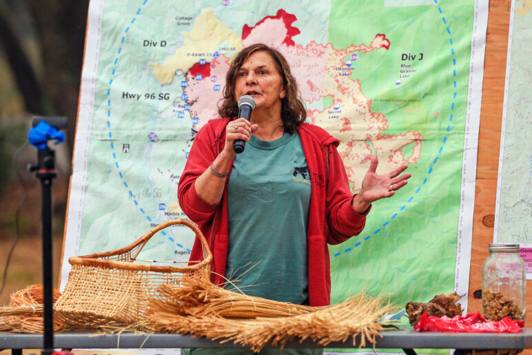 Kathy McCovey, a member of the Karuk Tribe who has studied using low-intensity fire to manage the ecosystem, speaks to firefighters assigned to the McCash Fire (2021) during morning briefing. Credit: Geoff Liesik, National. 