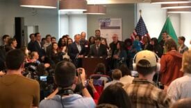 Gov Ferguson signing Washington state's Parking Reform and Modernization Act into law in front of a small crowd of supporters