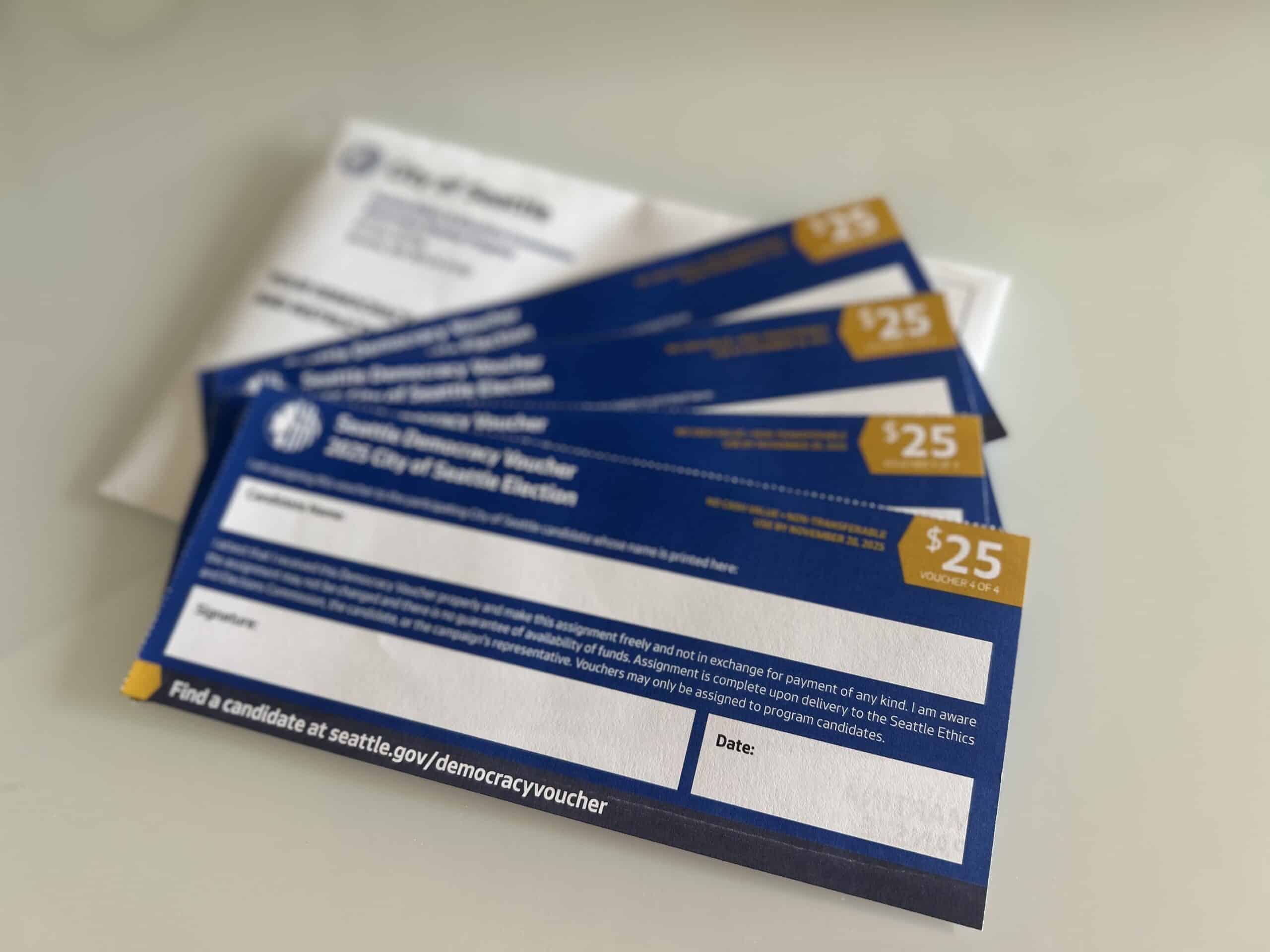 Three blue and white business cards with a white envelope.