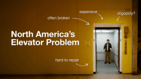 Screenshot from North America's Elevator Problem, featuring Uytae in an elevator against a yellow walled building