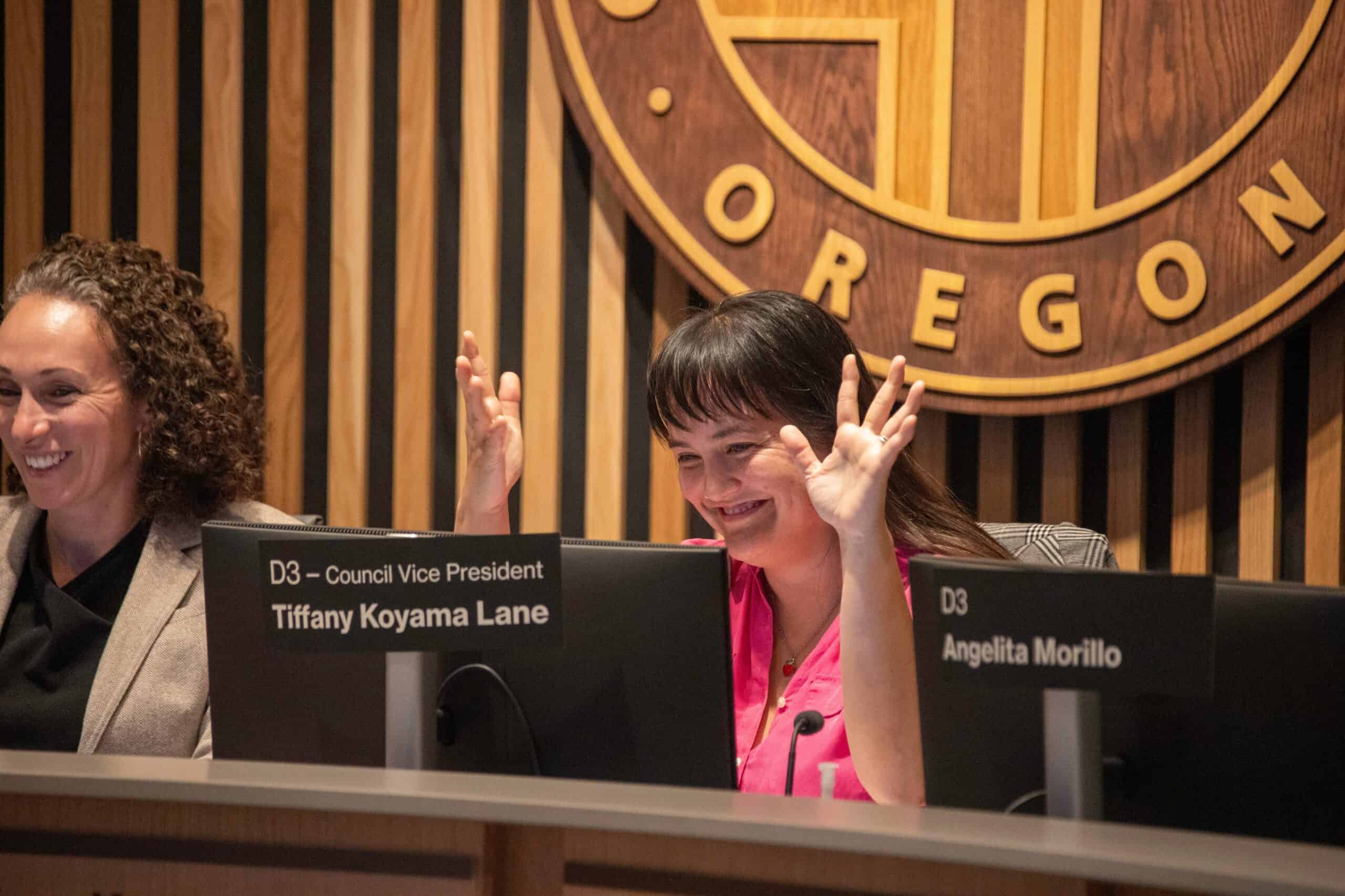 Portland, Oregon, city councilors Loretta Smith (left) and Tiffany Koyama celebrate a win at a Portland City Council hearing, October 2025. Portland is the largest jurisdiction in the United States to use proportional representation to elect its city council. Photo by Citizen Kepler, via Shutterstock.
