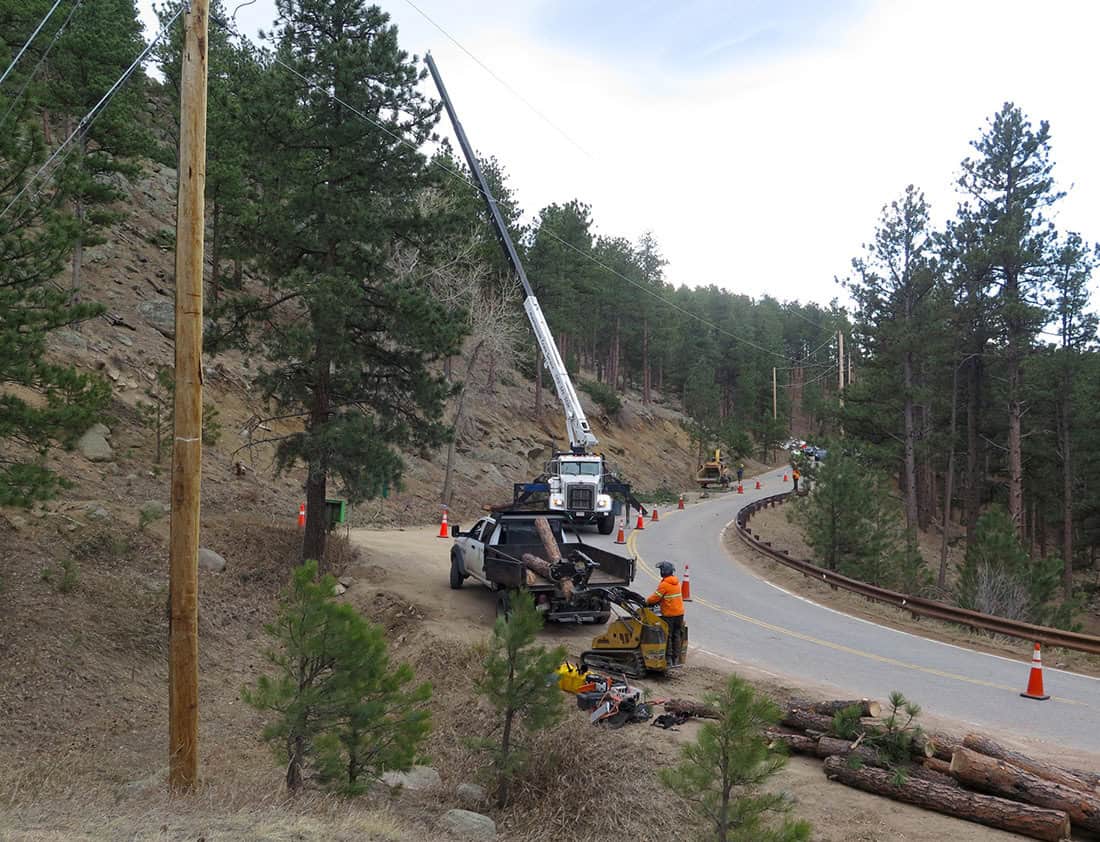 A crew in Sunshine Canyon, Colorado clears trees near power lines for wildfire mitigation in 2024. Northwest utilities plan to spend more than $700 million this year to cut trees, wrap wood poles in mesh, bury wires, inspect lines, and otherwise dampen fire danger. Photo by Boulder County.